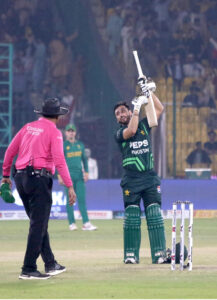 Pakistan's Salman Agha celebrates after scoring a century (100 runs) during the ODI cricket match of Tri-Nation series between Pakistan and South Africa at the National Stadium