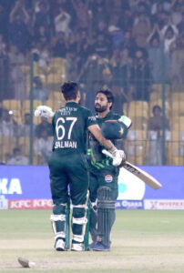Pakistan's captain Mohammad Rizwan celebrates after scoring a century (100 runs) with Salman Agha during the ODI cricket match of Tri-Nation series between Pakistan and South Africa at the National Stadium