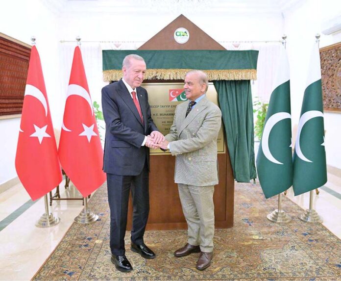 President of Turkiye, Recep Tayyip Erdogan and Prime Minister of Pakistan Muhammad Shehbaz Sharif shake hand after unveil the plaque of F-8 Interchange names after Recep Tayyip Erdogan
