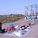 Little girl vendor sells tasbeeh and caps on the roadside near Chak Shahzad during the holy month of Ramadan in the Federal Capital