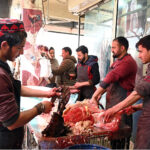 People purchasing meat at G-7 market in the Federal Capital