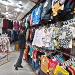 A vendor displaying garments on his shop to attract customers at Aabpara in the Federal Capital