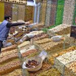 A vendor displaying dry fruits on his shop to attract customers at Aabpara in the Federal Capital
