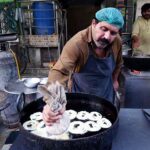 Vendor preparing traditional sweet item (Jalebi) for iftar during holy fasting month of Ramadan near Ghouri VIP in the Federal Capital