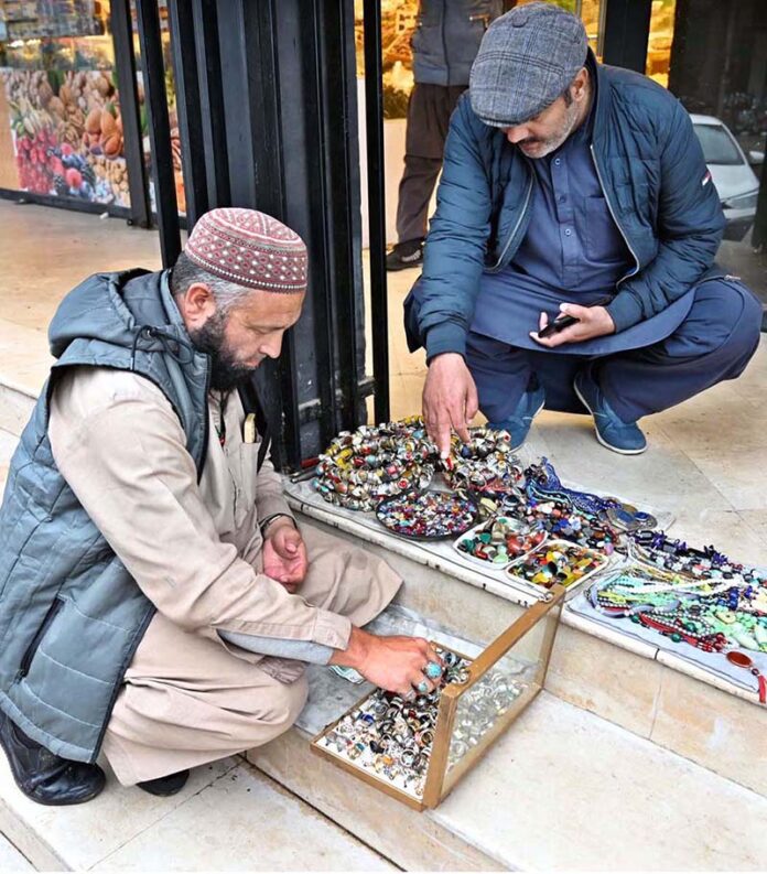 People selects and purchase precious stones at Aabpara in the Federal Capital