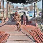 Workers are busy straightening the bamboos at their workplace