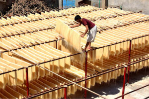 Workers are busy packing vermicelli (seviyan) after preparing it, as demand surges ahead of Eid-ul-Fitr