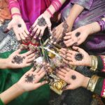 Girls are showing off their hands after applying mehndi designs in preparation for the upcoming Eid ul-Fitr