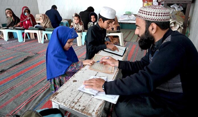 Children learning to recite Noorani Qaida from Qari at Jamia Masjid Al-Noor during the holy fasting month of Ramadan at G-7 in the Federal Capital