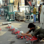 A worker is preparing room coolers at his workplace as per increasing demand in summer season