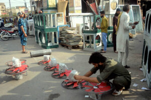 A worker is preparing room coolers at his workplace as per increasing demand in summer season