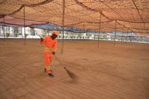 A worker is busy cleaning the Eidgah in preparation for Eid-ul-Fitr prayer