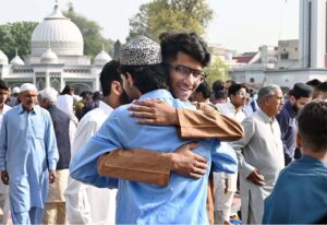 Federal Minister for Railways Hanif Abbasi exchanging Eid greetings with people after offering Eidul-Fitr prayers at Al- Aqsa Park, Satellite Town