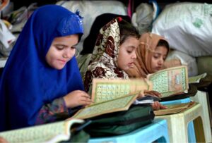 Children learning to recite Noorani Qaida from Qari at Jamia Masjid Al-Noor during the holy fasting month of Ramadan at G-7 in the Federal Capital