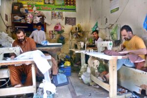 Tailors work tirelessly, stitching clothes to meet the high demand ahead of the upcoming Eid ul Fitr festival