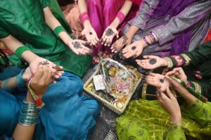 Girls are showing off their hands after applying mehndi designs in preparation for the upcoming Eid ul-Fitr