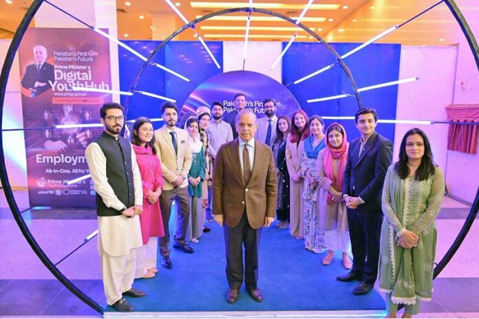 Prime Minister Muhammad Shehbaz Sharif in a group photo with the high-achievers and beneficiaries of different initiatives under PM's Youth Programme at the launching ceremony of Prime Minister's Digital Youth Hub
