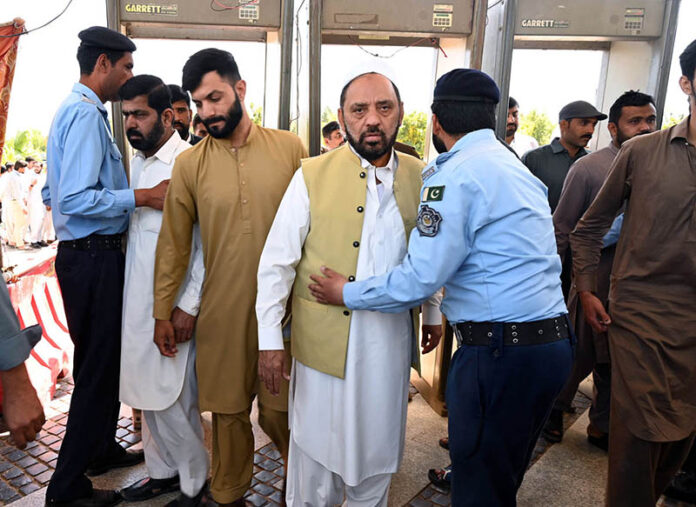 Police officials conduct security checks of faithful before Namaz-e-Juma-tul-Wida at Faisal Masjid during the holy month of Ramzan