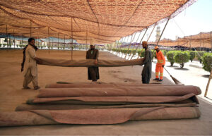 A worker is busy cleaning the Eidgah in preparation for Eid-ul-Fitr prayer