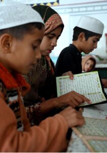 Children learning to recite Noorani Qaida from Qari at Jamia Masjid Al-Noor during the holy fasting month of Ramadan at G-7 in the Federal Capital
