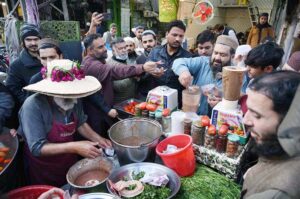 A large number of customers purchase traditional chatni (sauce) from roadside vendor at Qissa Khawani Bazaar.