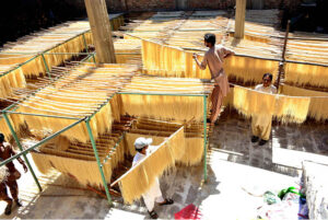 Workers are busy packing vermicelli (seviyan) after preparing it, as demand surges ahead of Eid-ul-Fitr