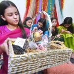 Girls busy in making mehndi designs on their hands during the preparation for the upcoming Eid ul Fitr