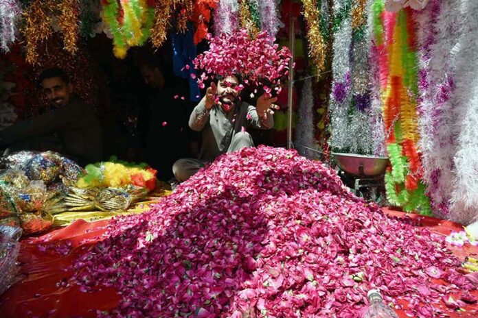 A vendor displaying the flowers to attract the customers in connection with Eidul Fitr at Flowers Market