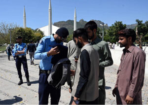 Police officials conduct security checks of faithful before Namaz-e-Juma-tul-Wida at Faisal Masjid during the holy month of Ramzan