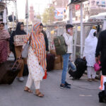 Passengers gathered at the bus terminal, preparing to travel to their hometowns for Eid-ul-Fitr celebrations