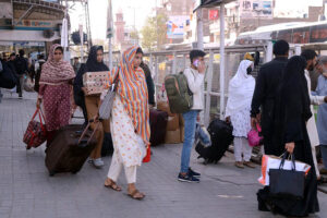 Passengers gathered at the bus terminal, preparing to travel to their hometowns for Eid-ul-Fitr celebrations