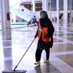 As observing International Women's Day around the globe, a woman worker cleaning the floor of Faisal Masjid in preparation of Friday Prayer