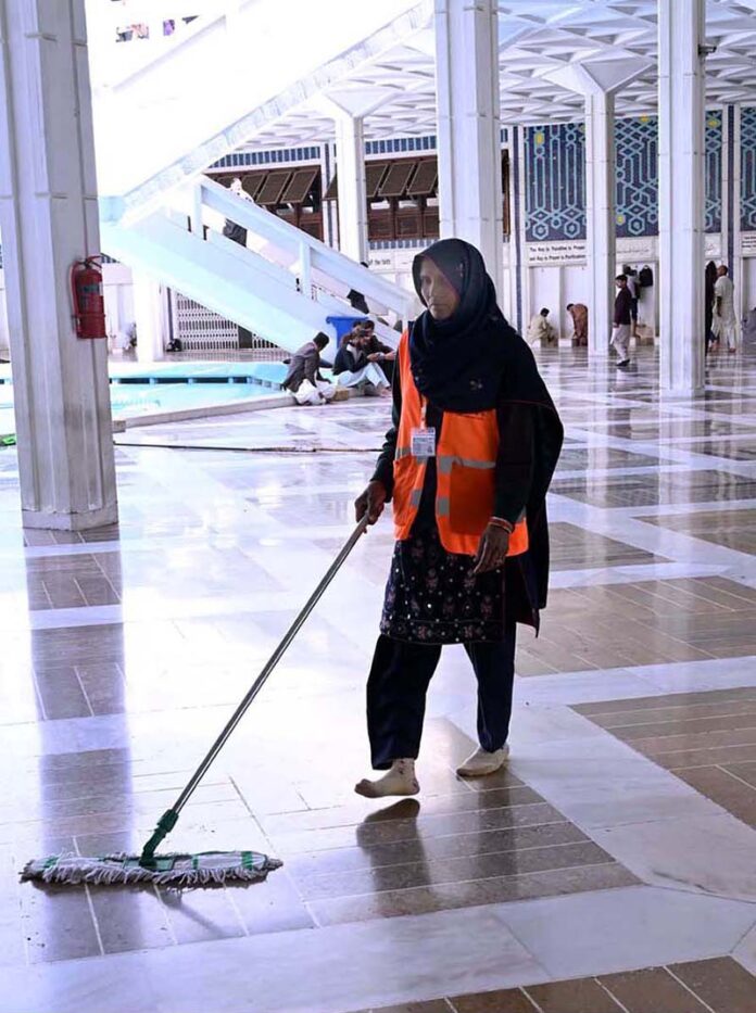 As observing International Women's Day around the globe, a woman worker cleaning the floor of Faisal Masjid in preparation of Friday Prayer