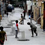 Youngsters playing cricket in a street at G-6 area in the Federal Capital