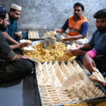 Workers busy in preparing traditional food item samosas before frying at their workplace during the Holy Month of Ramadan-ul-Mubarak