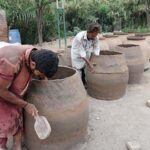 Workers busy making a traditional oven (tandoor) at Railway Road