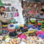Vendors are busy arranging and displaying bangles to attract the customers at Jinnah Super Market in the Federal Capital in connection with upcoming Eidul Fitr