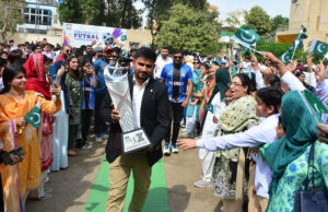 An official carries the HBL PSL trophy upon arrival during the HBL PSL Trophy Tour 2025 at Foundation Public School.