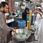 Workers dying clothes as per customers demand ahead of Eid-ul-Fitr at Aabpara Market