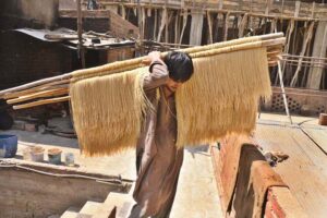 A labourer arranging and dries vermicelli (seviiyan) after preparing as the demand for traditional sehri item during the holy month of Ramazan at local factory
