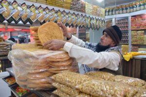 A shopkeeper displaying ‘pheni’ to attract the customers at Masjid Road during holy fasting month of Ramzan-ul-Mubarak.