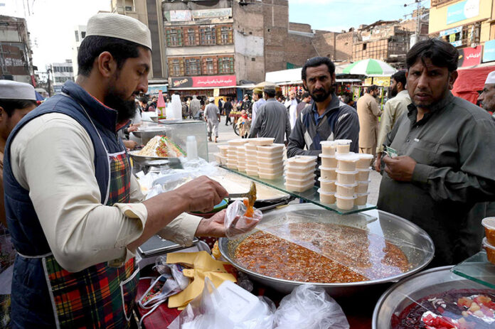Vendor selling traditional sweet food item Kheer and Murabba at Fawara Chowk during the Islamic fasting month of Ramazan ul Mubarak