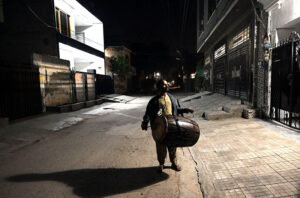 A drum beater walks the streets, beating his drum to wake Muslims for their pre-dawn 'Sehri' meal before another day of fasting begins in Ramzan-ul-Mubarak.
