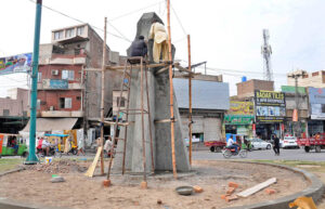Labourers are busy with the construction of the Monument at Dera Adda Chowk during beautification work in the city.