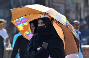 Women waiting for a passenger bus to leave for their hometown at the General Bus Stand to celebrate Eid ul Fitr festival with their loved ones