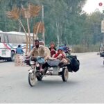 A nomad family navigates the roads of Bahawalpur on a motorcycle rickshaw