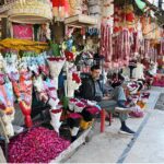 A vendor displaying flower bouquets to attract customers at flower Market Banni Chowk