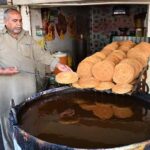 A vendor preparing traditional food item Pheoni in connection with Holy Fasting Month of Ramadan at Banni Chowk