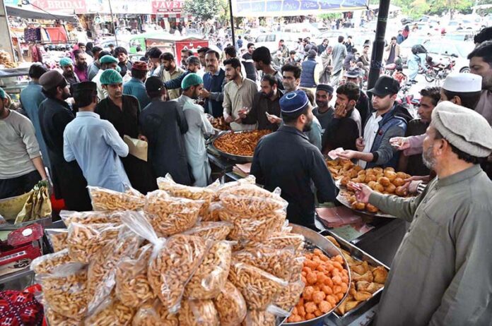 Large number of people purchasing goods for 
