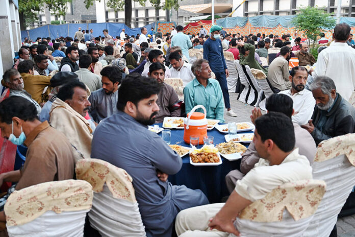A large number of people sitting for monthly Iftar program at Allama Iqbal Teaching Hospital